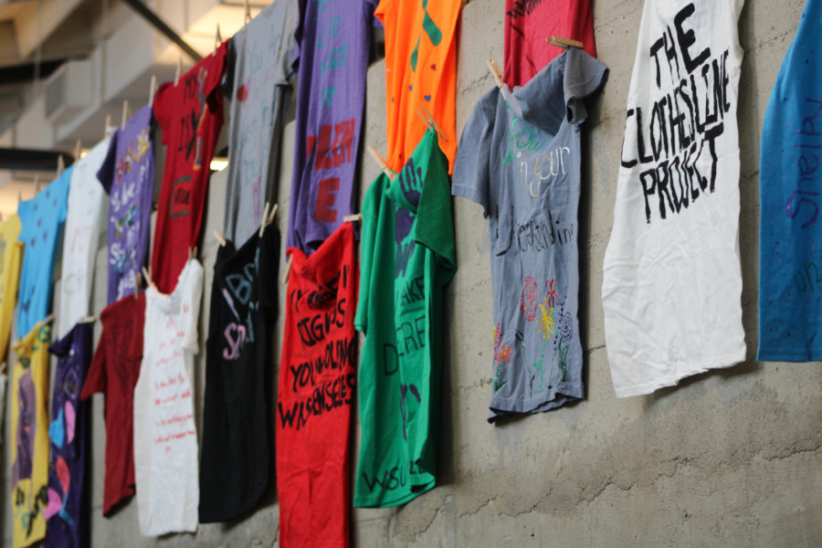 Painted T-shirts were hung up in the hallway leading towards the event as part of the Clothesline Project. The project aims to raise awareness for survivors of assault and abuse.