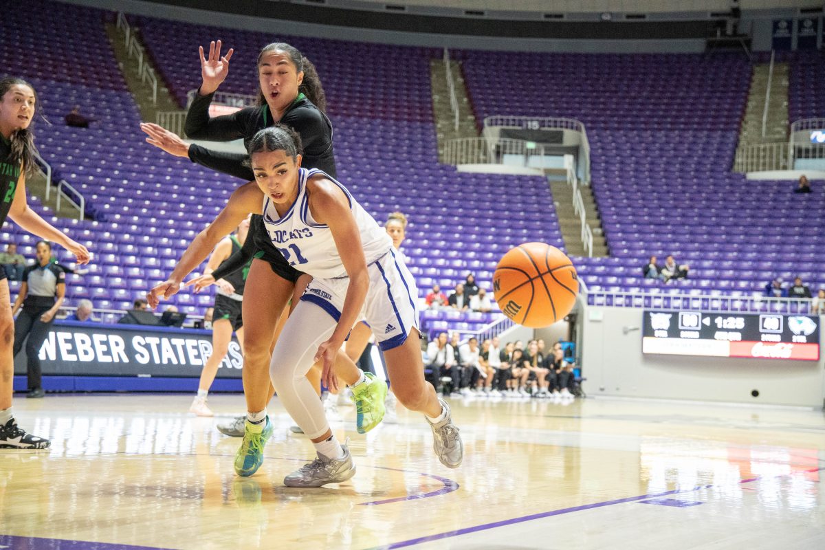 Forward Daryn Hickok #21 attempting to grab a basketball after a UVU player knocks it out of her hands. Photo taken in November 2022 at the game against Utah Valley University.