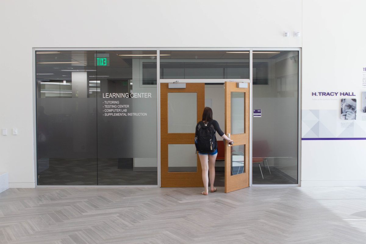A student entering the learning center located on the first floor of Tracy Hall in room 101 in 2017.