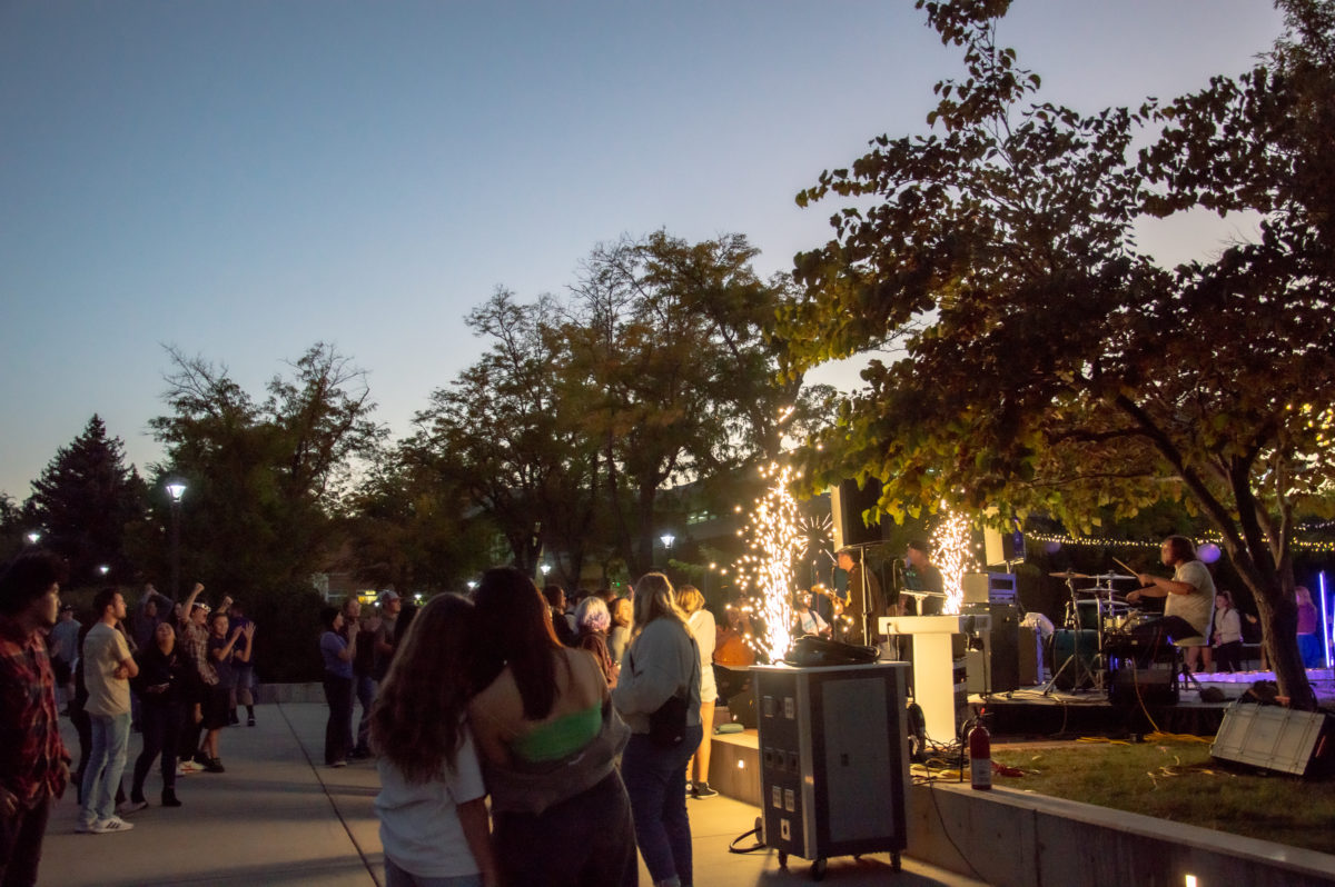 A crowd of students dancing and singing with the band at the Light the W event in 2022.