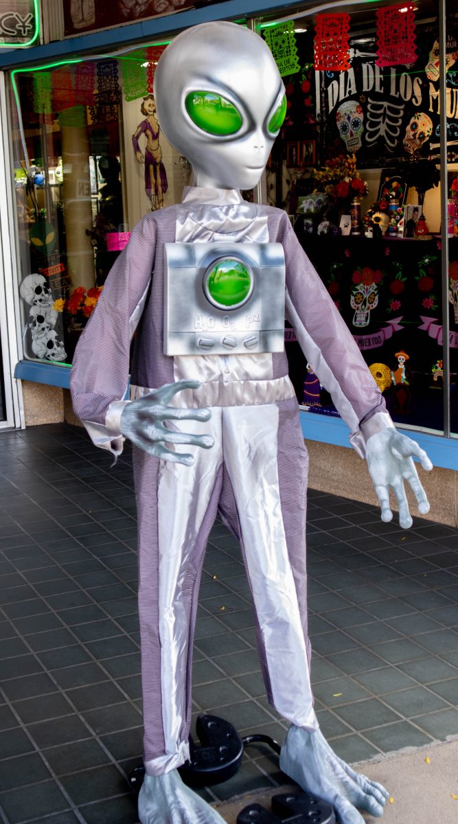 An alien mannequin greeting customers outside the Alien Legacy store.