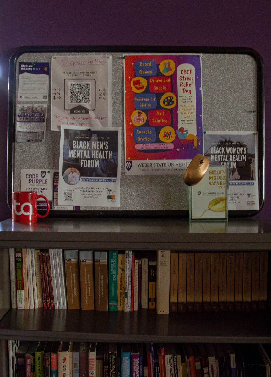 The Black Cultural Center provides a shelf filled with books, board games and upcoming events.