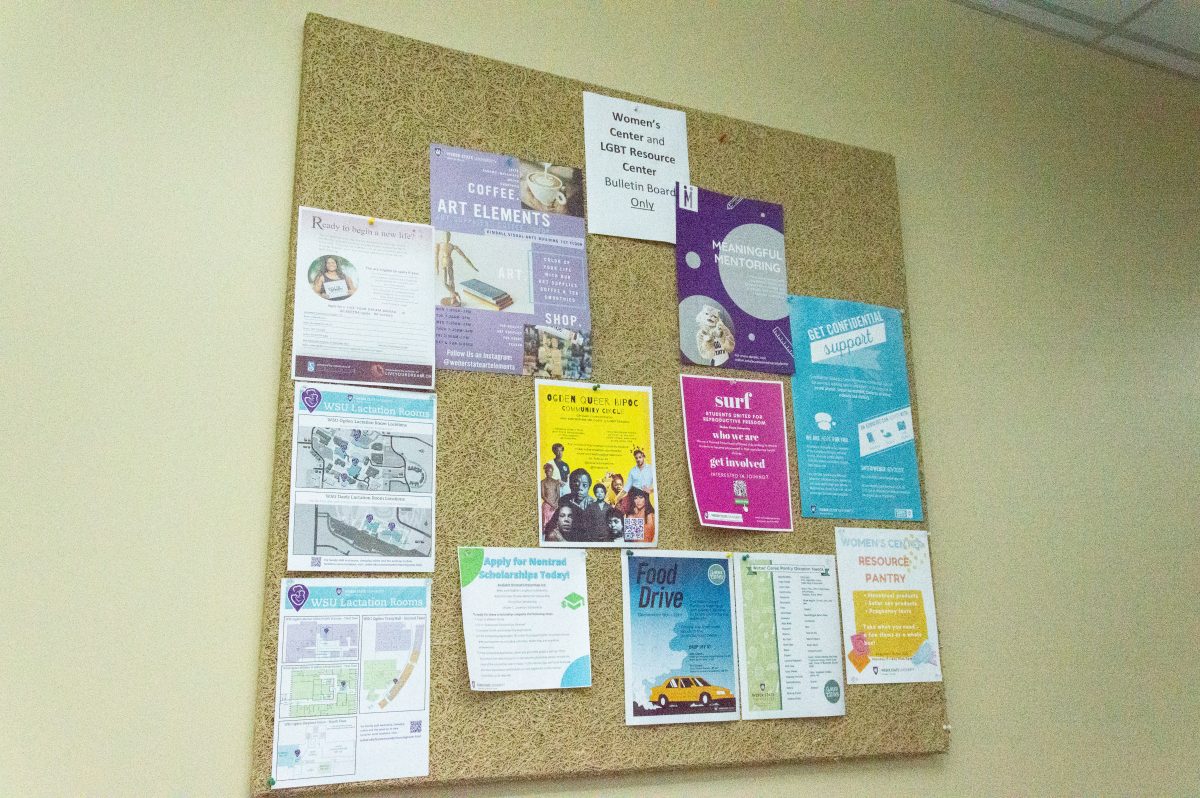 A board on the outside of the Womens Center with information posted about the center.