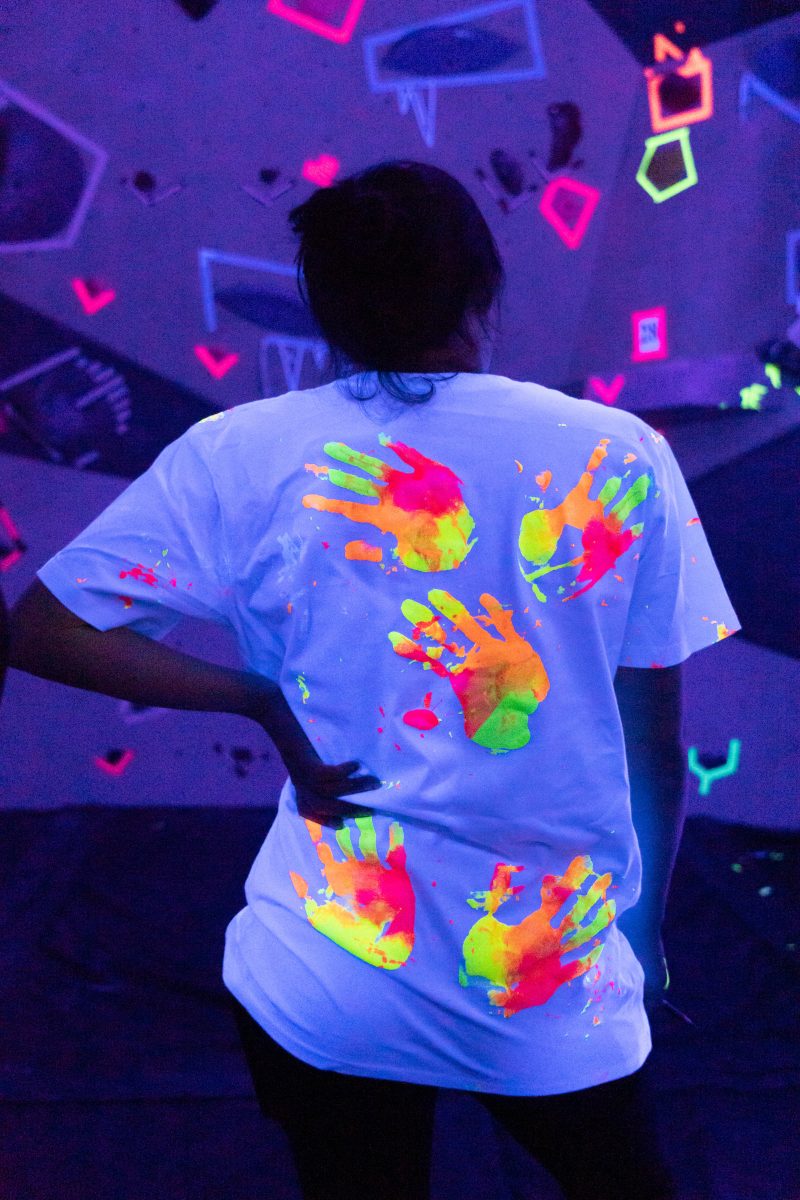 Covered in neon paint, students used their hands to create the artwork on their t-shirts.