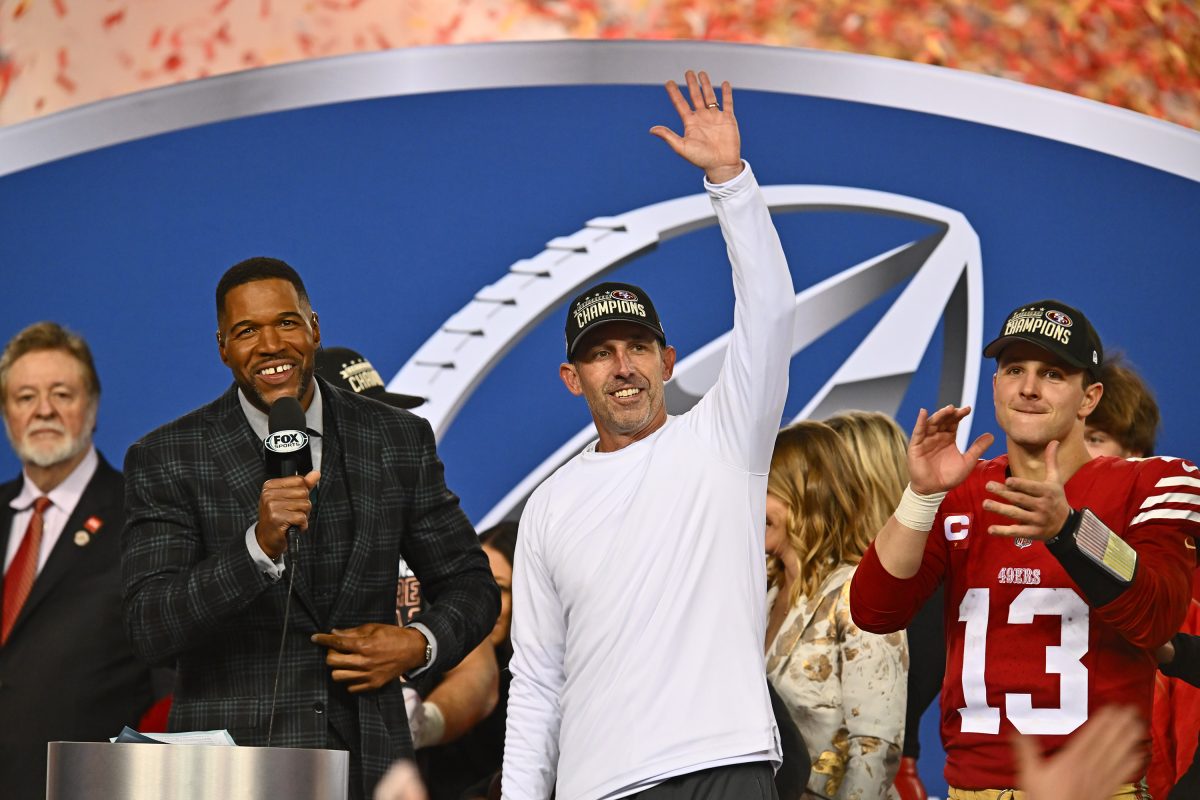 San Francisco 49ers head coach Kyle Shanahan waves to the crowd during the trophy ceremony after winning the NFC Championship Game at Levis Stadium in Santa Clara, Calif., on Sunday, Jan. 28, 2024.