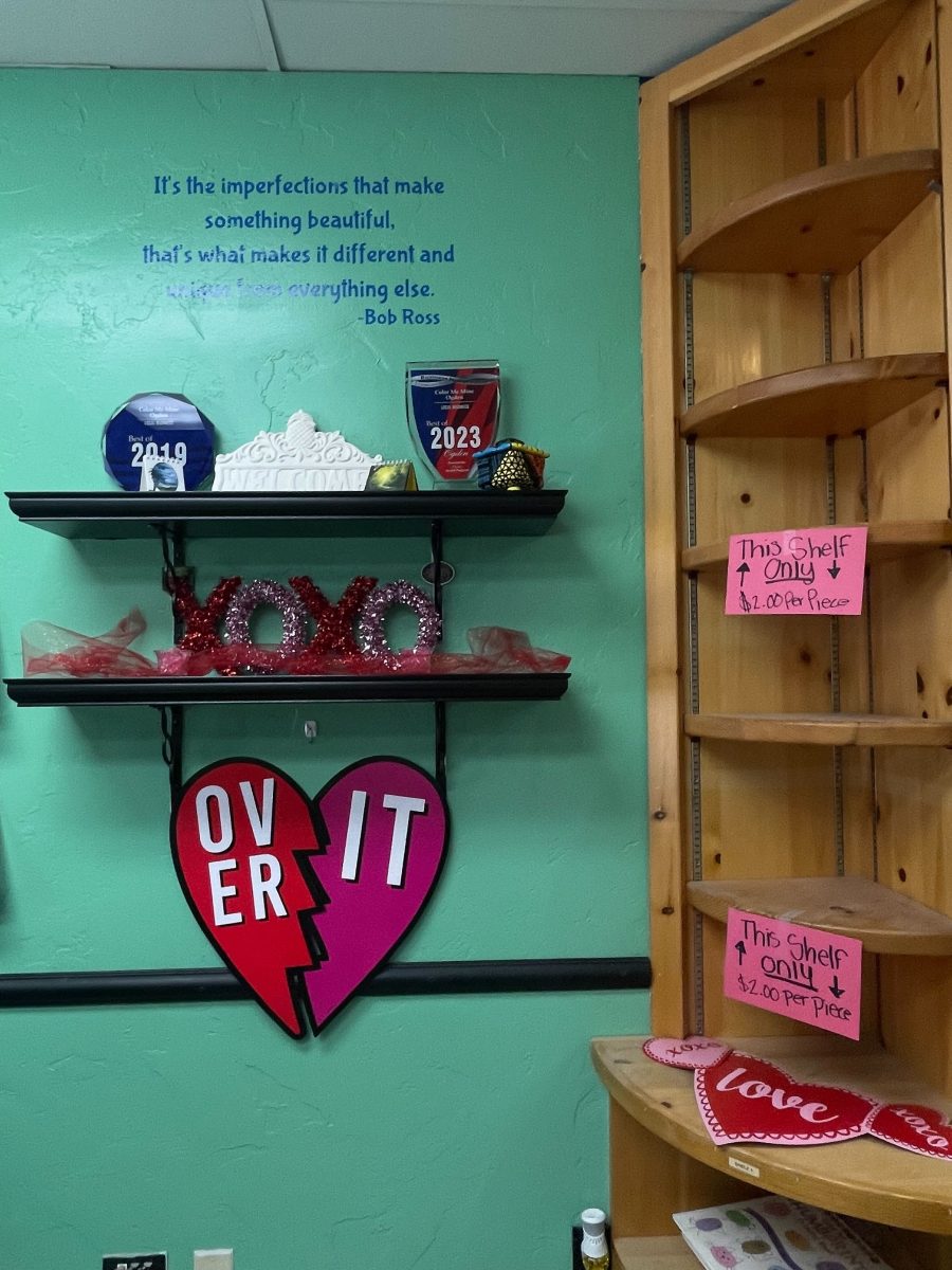 Valentines Day decorations inside of Color Me Mine next to empty shelves that had pottery pieces on sale.