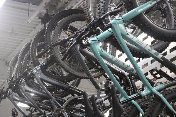 Rental mountain bikes hang from bike racks inside of the Outdoor Rec Center.