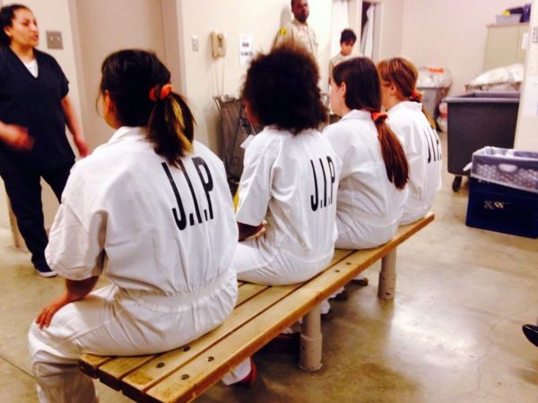 Juvenile inmates in the Juvenile Intervention Program sitting together in a Juvenile Center.