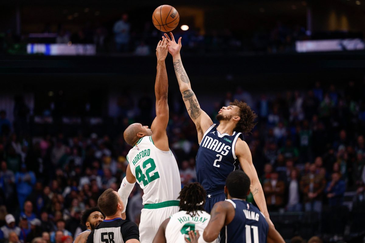Boston Celtics center Al Horford (42) and Dallas Mavericks center Dereck Lively II (2) reach for the opening tip during the first half of an NBA game, Monday, Jan. 22, 2024, in Dallas.