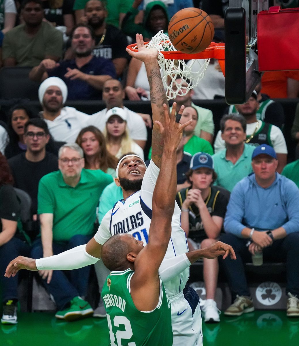 Boston Celtics center Al Horford (42) scores past Dallas Mavericks center Daniel Gafford (21) during the first half in Game 5 of the NBA Finals on Monday, June 17, 2024, in Boston.