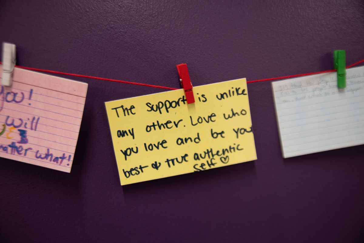 Yellow note at the exhibit telling members of the LGBTQ+ community to Love who you love.