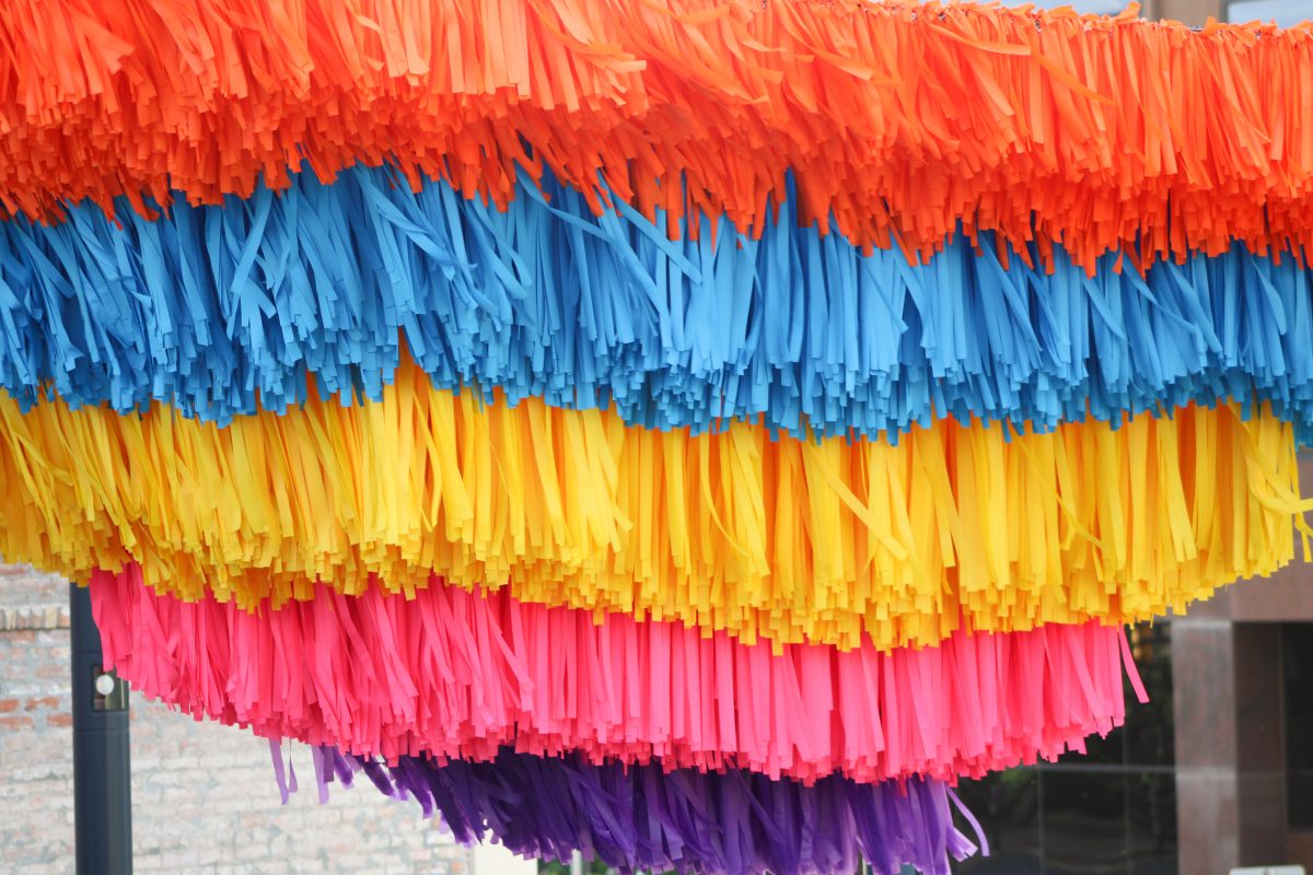 Various colored ribbons hang above the Dumke Arts Plaza.