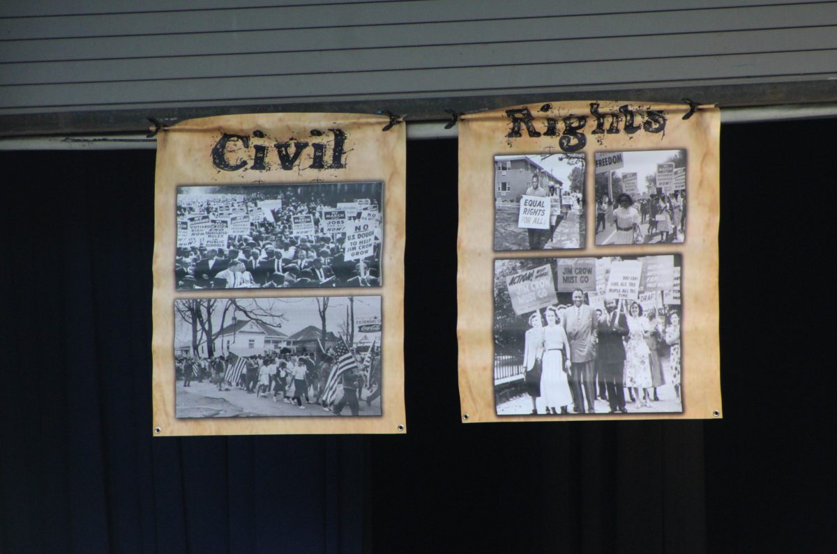 Posters with the title Civil Rights and photos from the Civil Rights Movement during Jim Crow, hang above the Ogden Amphitheater during the Juneteenth Festival 2023.