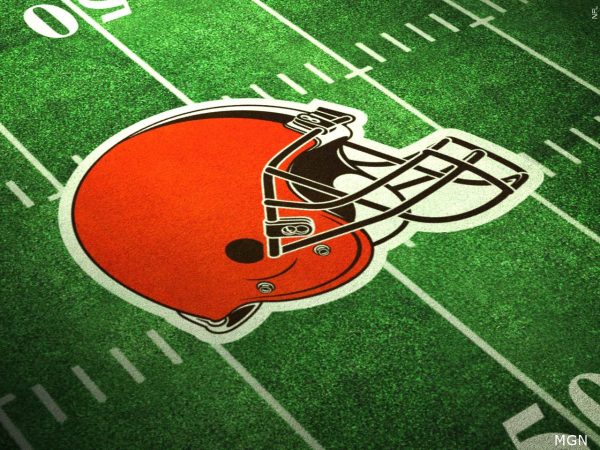 The Cleveland Browns logo printed on a football field.