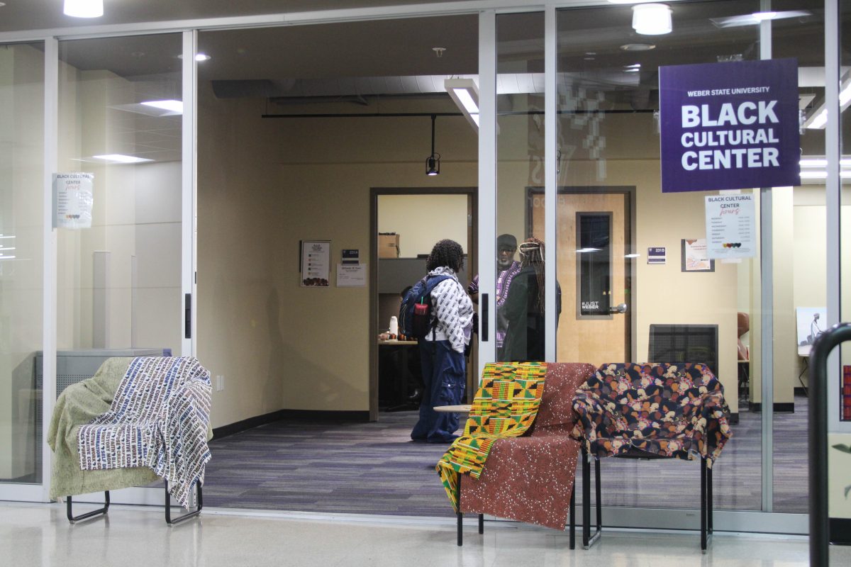 Weber State University students talking with each other inside of the Black Cultural Center.