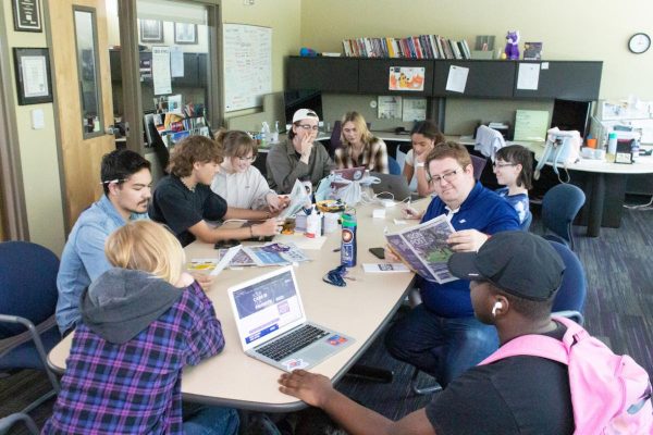 The Signpost 2022-2023 staff gathered around the table. 