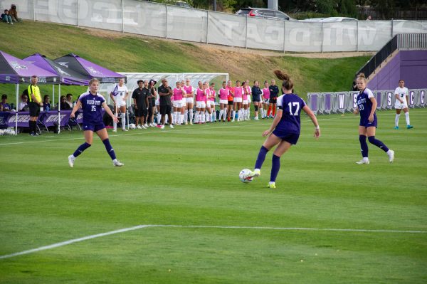 Weber State Women's Soccer Midfield, Samantha Kearns (#17), dribbling the ball down the field as fellow teammates, stand nearby to defend the ball.