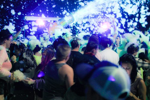 A foam canon shoots out foam over crowds of Weber students.