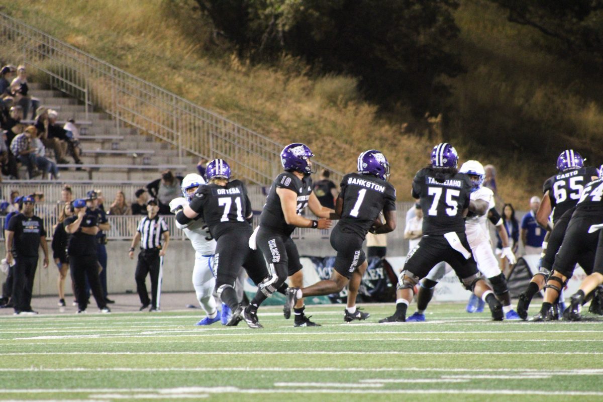 Weber State Quarterback, Richie Munoz (#10), passing the ball off to Running back, Damon Bankston (#1).