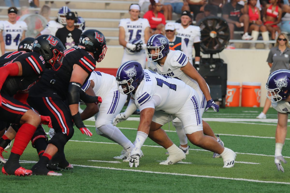 Weber State Defensive Tackle, Kaufusi Pakofe Jr. (#72), lined up against Lamar University players.