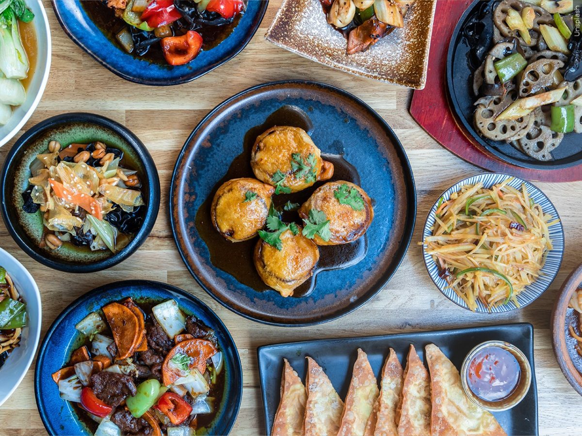 A spread of various dishes laid out on top of a table.