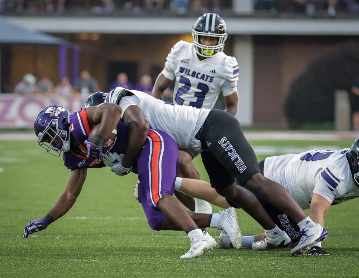 Kemari Bailey (#35), being tackled as he tries to keep an opposing player from getting the ball away from him.