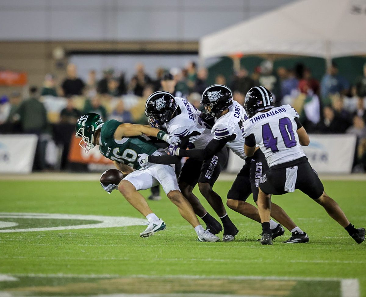 Frankie Edwards (29) and BJ Carey (3), rallying to a tackle.