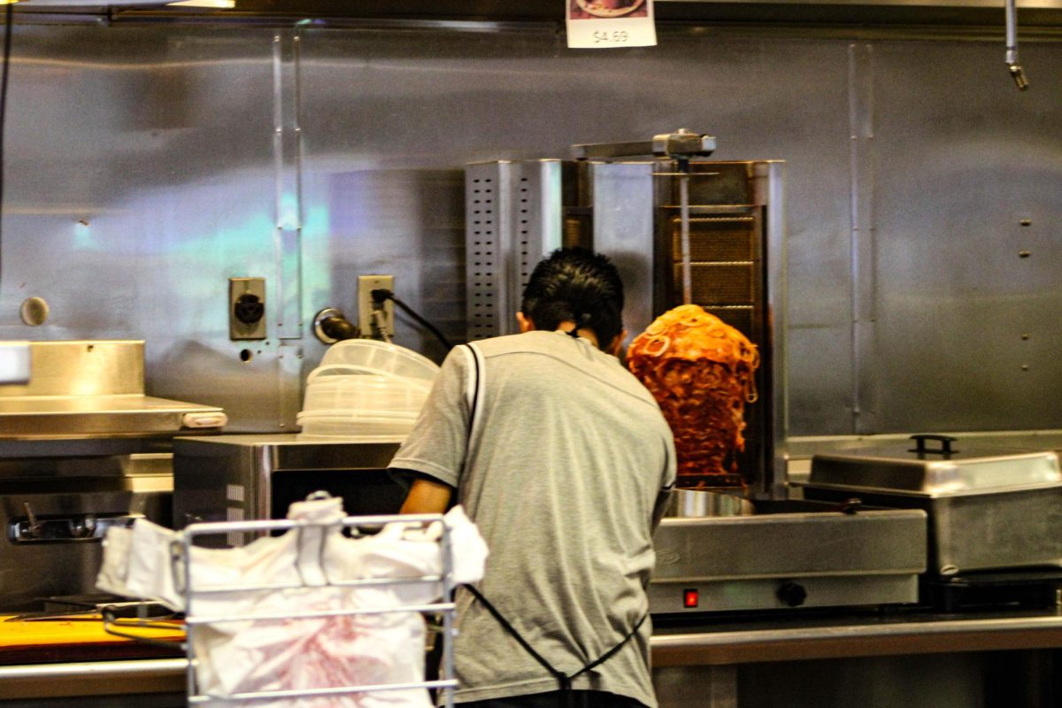 One of the cooks at Don Carlos Street Tacos preparing food for customers.