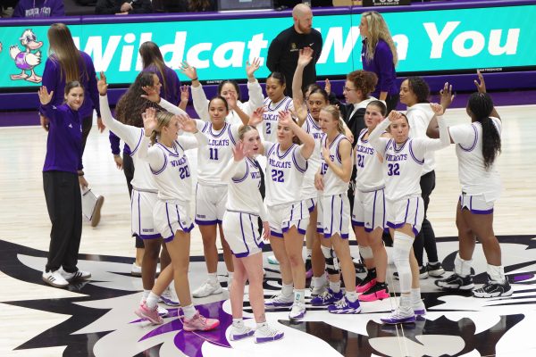 Weber State Women's Basketball team waving towards the crowd after a basketball game.