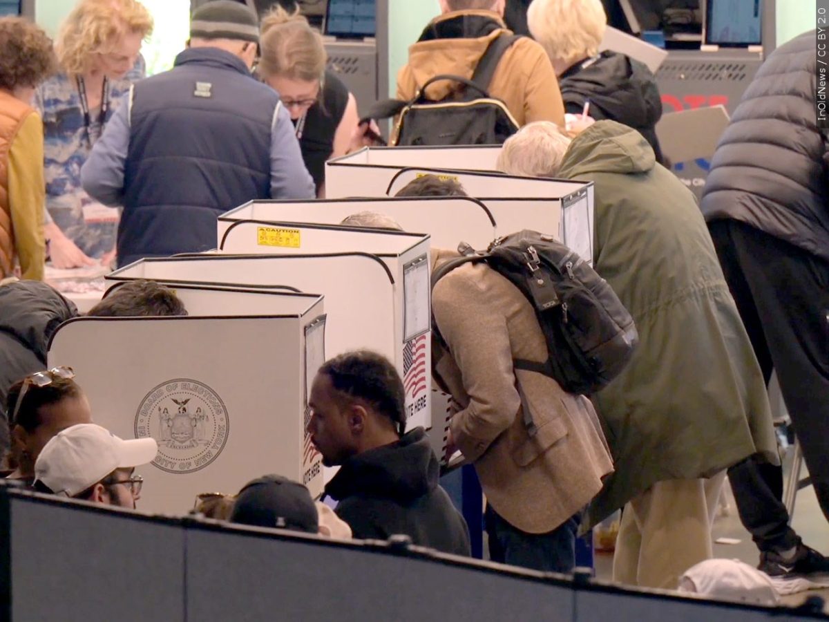 People fill out in-person ballots at a polling location during Election Day for the 2024 Election season.