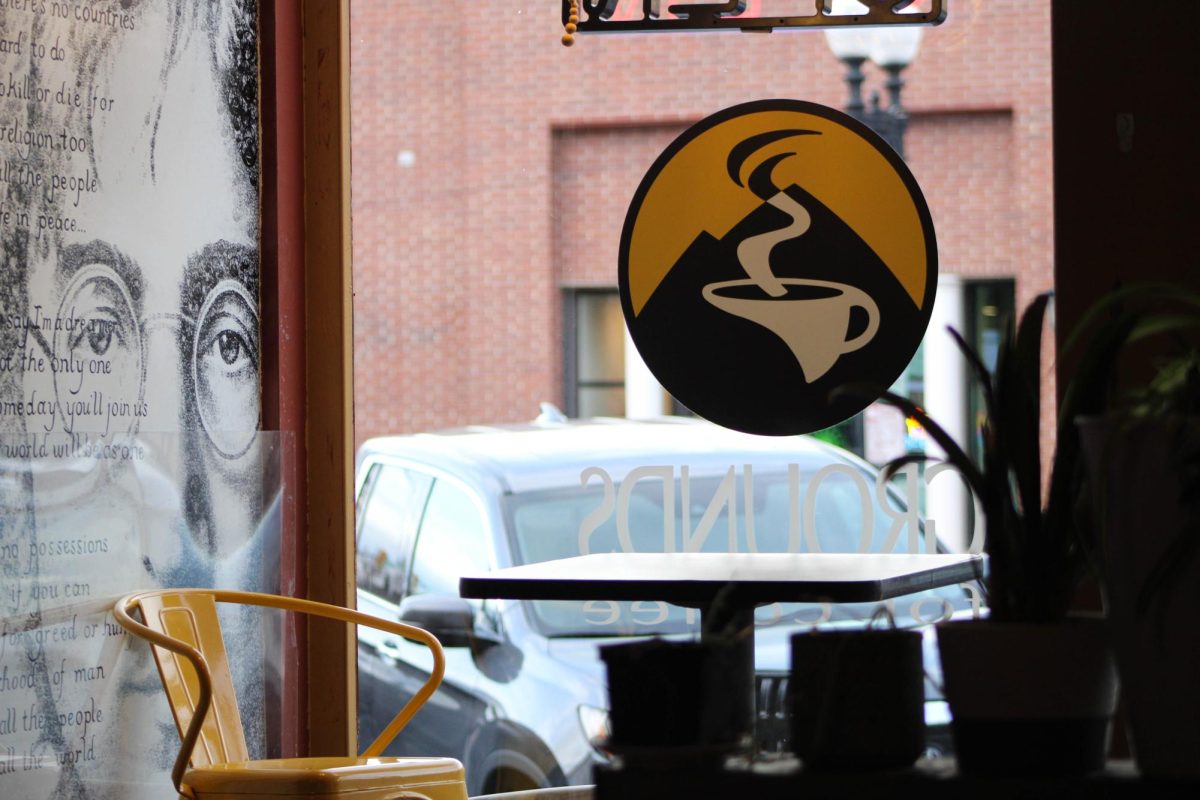 A small table sits in the front windows for the Grounds for Coffee shop on Historic 25th Street.