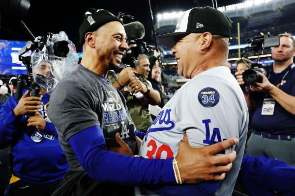 NEW YORK, NEW YORK - OCTOBER 30:  Manager Dave Roberts #30 of the Los Angeles Dodgers celebrates with Mookie Betts #50 after the Dodgers defeated the New York Yankees 7-6 in Game Five to win the 2024 World Series at Yankee Stadium on October 30, 2024 in the Bronx borough of New York City. 