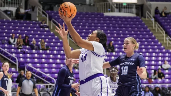 Women's Basketball, Mata Peaua (#44), going for toss at the basket as opposing players close in.