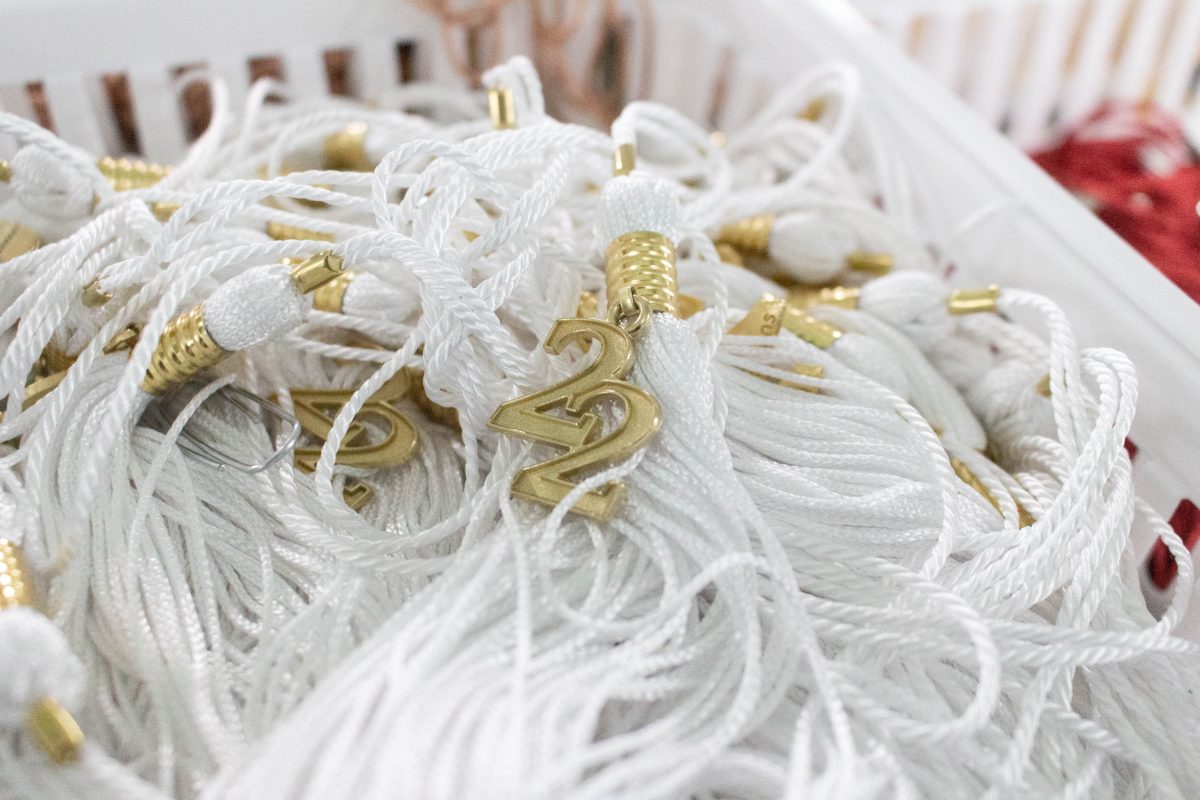 A basket of white 2022 graduation tassels for graduates.