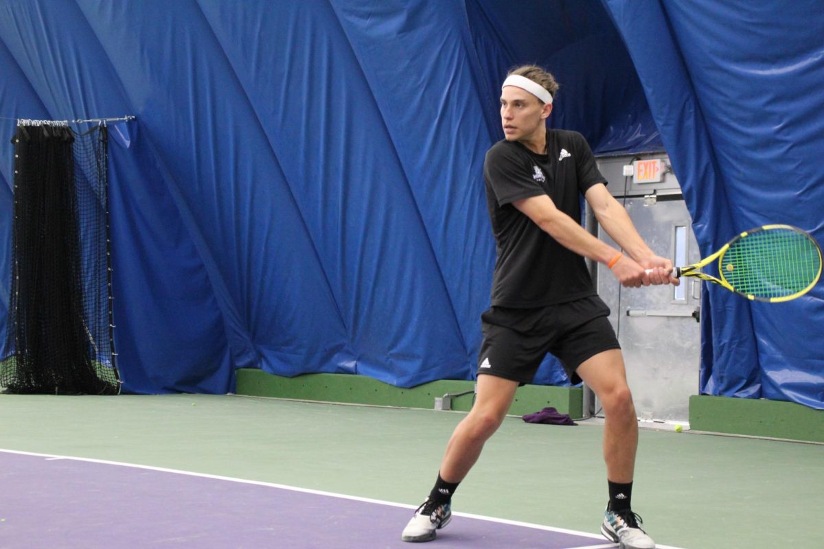 Sebastian Buxman levels his racket and eyes the tennis ball and his opponents movement.