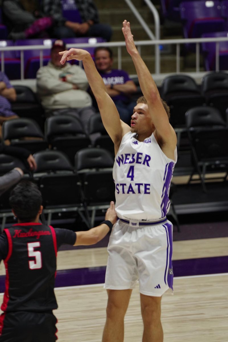 Forward, Dyson Koehler (#4), making a pass with the ball away from an opposing basketball player.