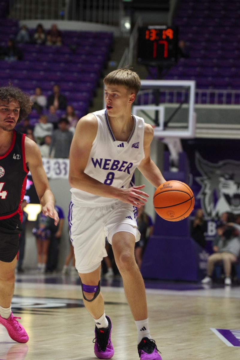 Guard/Forward Viljami Vartiainen (#8), dribbling the ball away from an opposing basketball player.