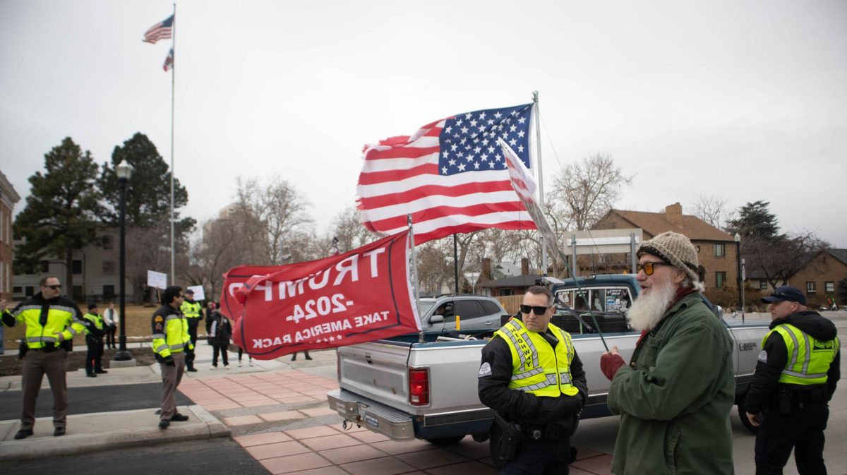 A protestor shouts at a pro-Trump truck passing by.