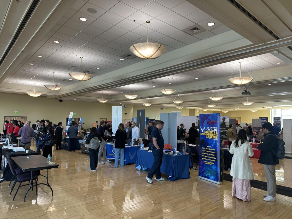 Students visiting employer booths at the career fair.