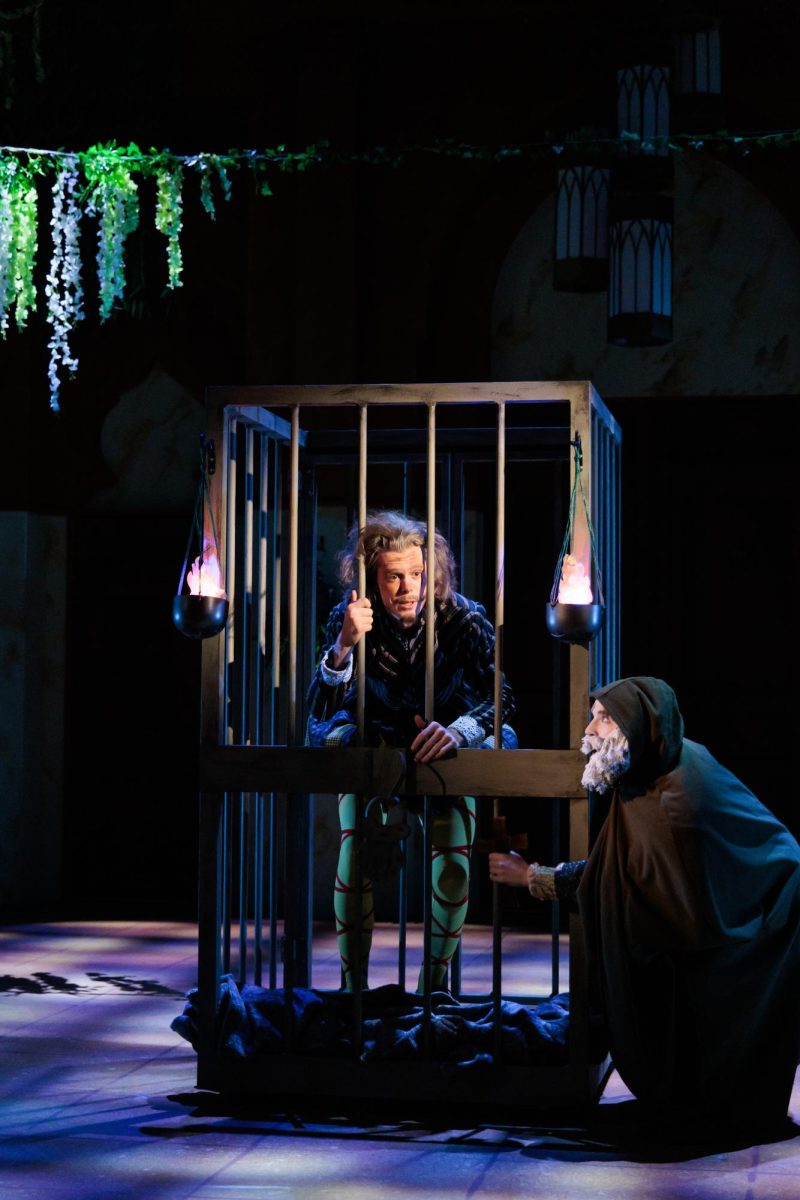 Taylor Garlick as Malvolio locked in a cage during a scene in "Twelfth Night".