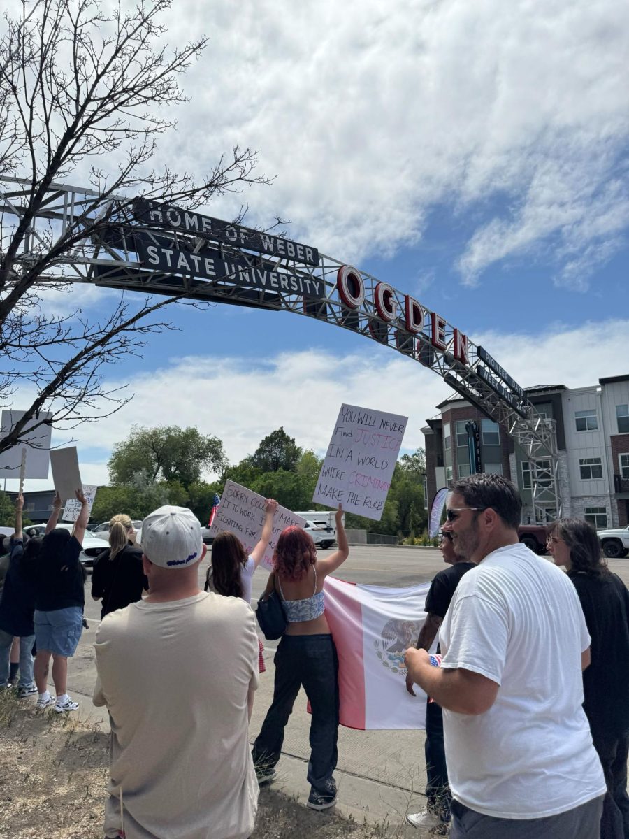 Protesters march from the Union Station to the Ogden Arch to hold up protest signs and chant to passerbys.