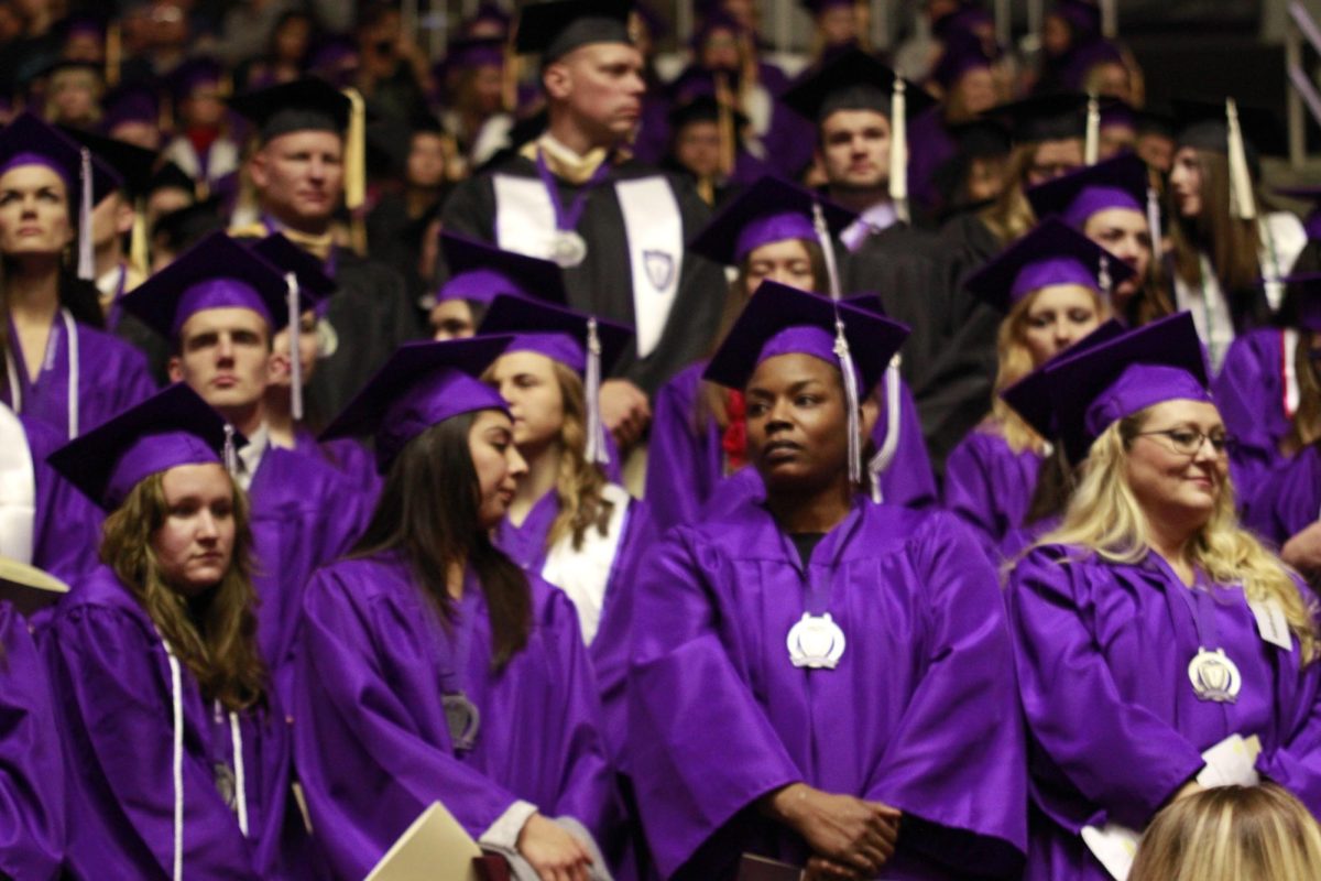 Graduating students dressed in purple and black graduation gowns. Photo taken in 2016.// Estudiantes que se gradúan vestidos con batas y togas de color morado y negro. Foto tomada en 2016.