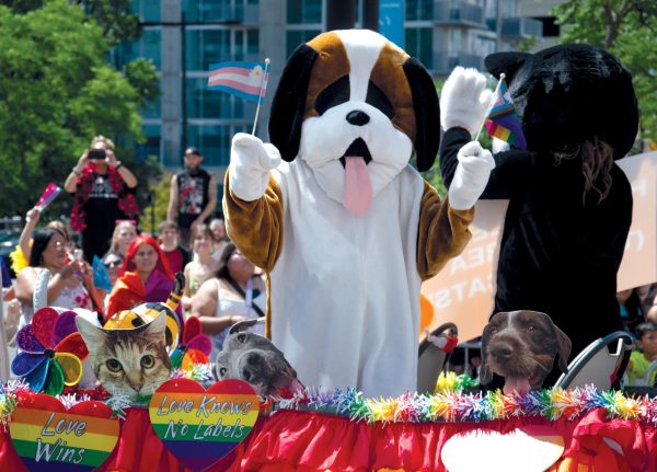 A pet-themed float waves to the crowd and flaunts LGBTQ+ flags at the Pride Parade on June 7, 2026.