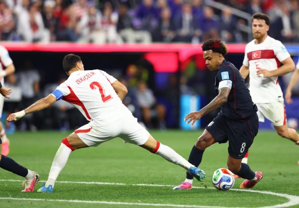 United States Soccer player skirmishes past a Turkey player in the World Cup on June 25, 2026.