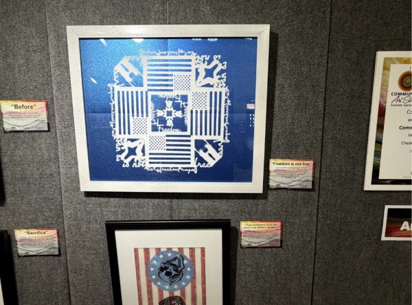 A blue art piece hangs on an art wall at Ogden's Historic Union Station.