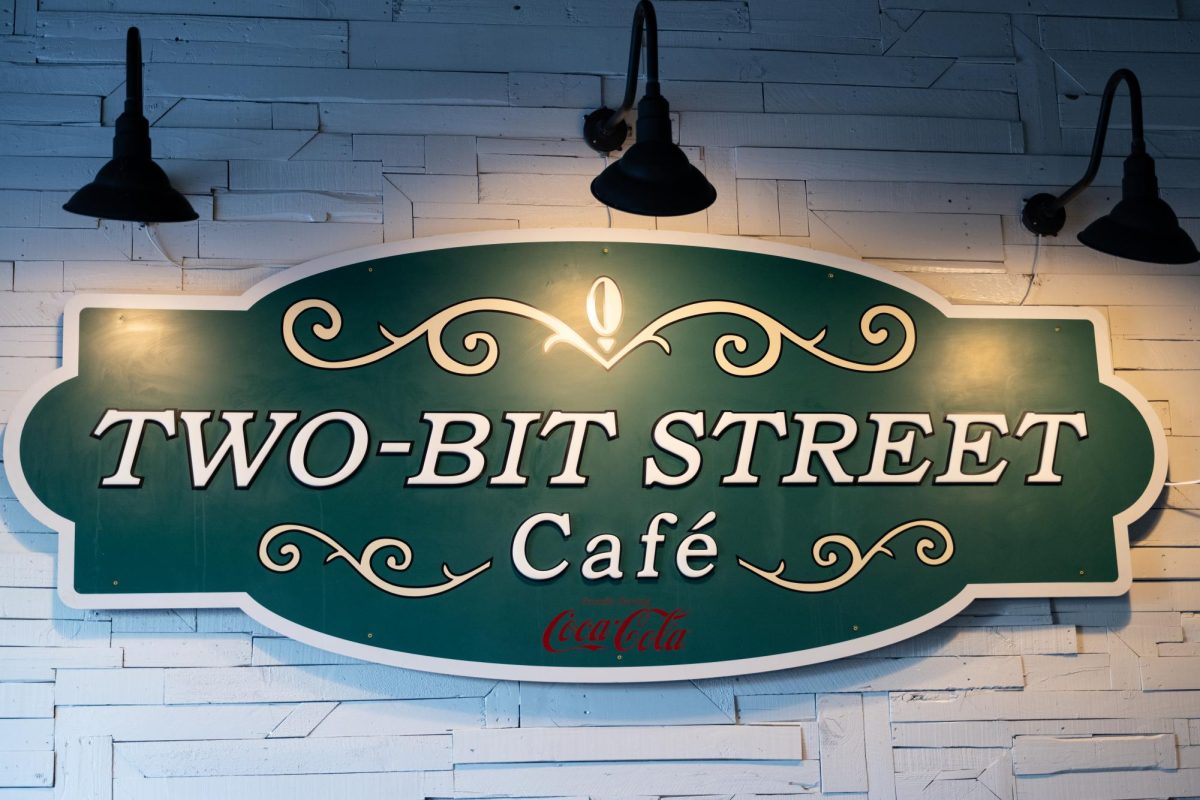The Two-Bit Street Cafe sign displayed on the wall inside of the Two-Bit Bistro. // El letrero del Two-Bit Street Cafe que se muestra en la pared dentro de Two-Bit Bistro.