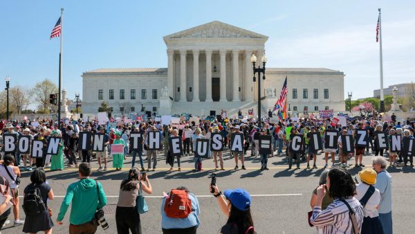 Demonstrators hold letters making up the slogan "Born in the USA = citizen!" outside the U.S. Supreme Court building as the court hears oral arguments on the legality of the Trump administration's effort to limit birthright citizenship for the children of immigrants, in Washington, D.C., U.S., April 1, 2026.
